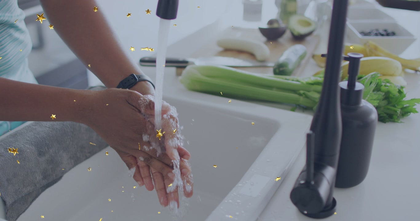 Woman turning black faucet, wetting, lathering, rinsing hands while cooking, golden stars floating