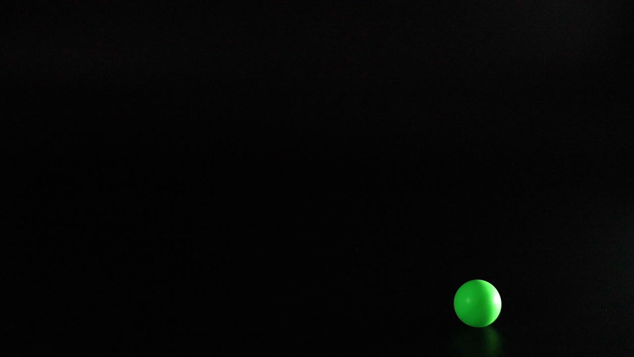 Multiple colored balls bouncing in dark space
