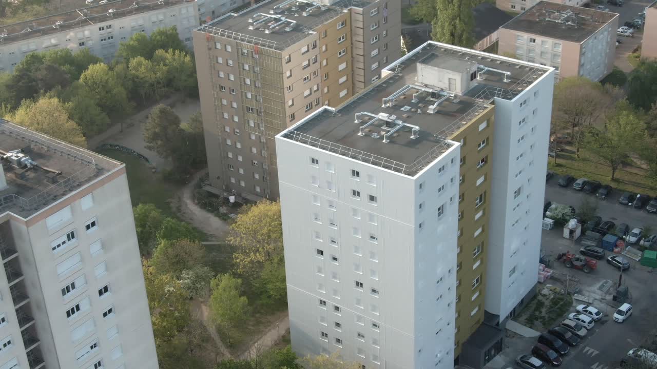 Drone view over social housing apartment blocks in urban residential estate, tower blocks, often used to depict poverty or community living, France