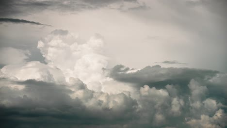 Dramatic-dark-rainy-puffy-clouds-form-and-rise-in-sky