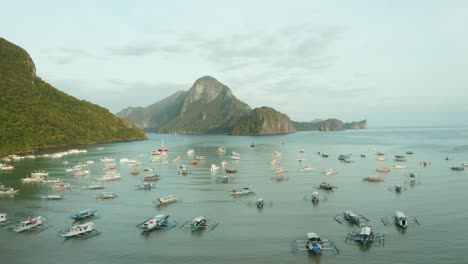 WS-AERIAL-Lots-of-boats-in-harbor-and-sea,-El-Nido,-Palawan,-Philippines