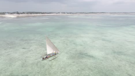 Small-wooden-boat-sailing-on-coast-of-Africa-with-local-fisherman