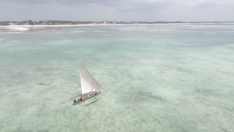 small wooden boat sailing on coast of africa with local fisherman