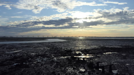 Right-Pan,-Bridge-over-the-Bay-of-Biscay-to-the-island-d'Oleron-at-sunrise,-Fort-Louvois-in-the-background,-Charente,-France