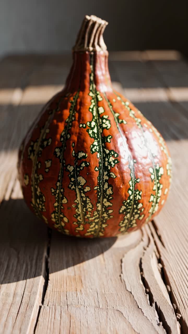 Close-up, angled shot of a textured pumpkin on a rustic wooden table, capturing natural light