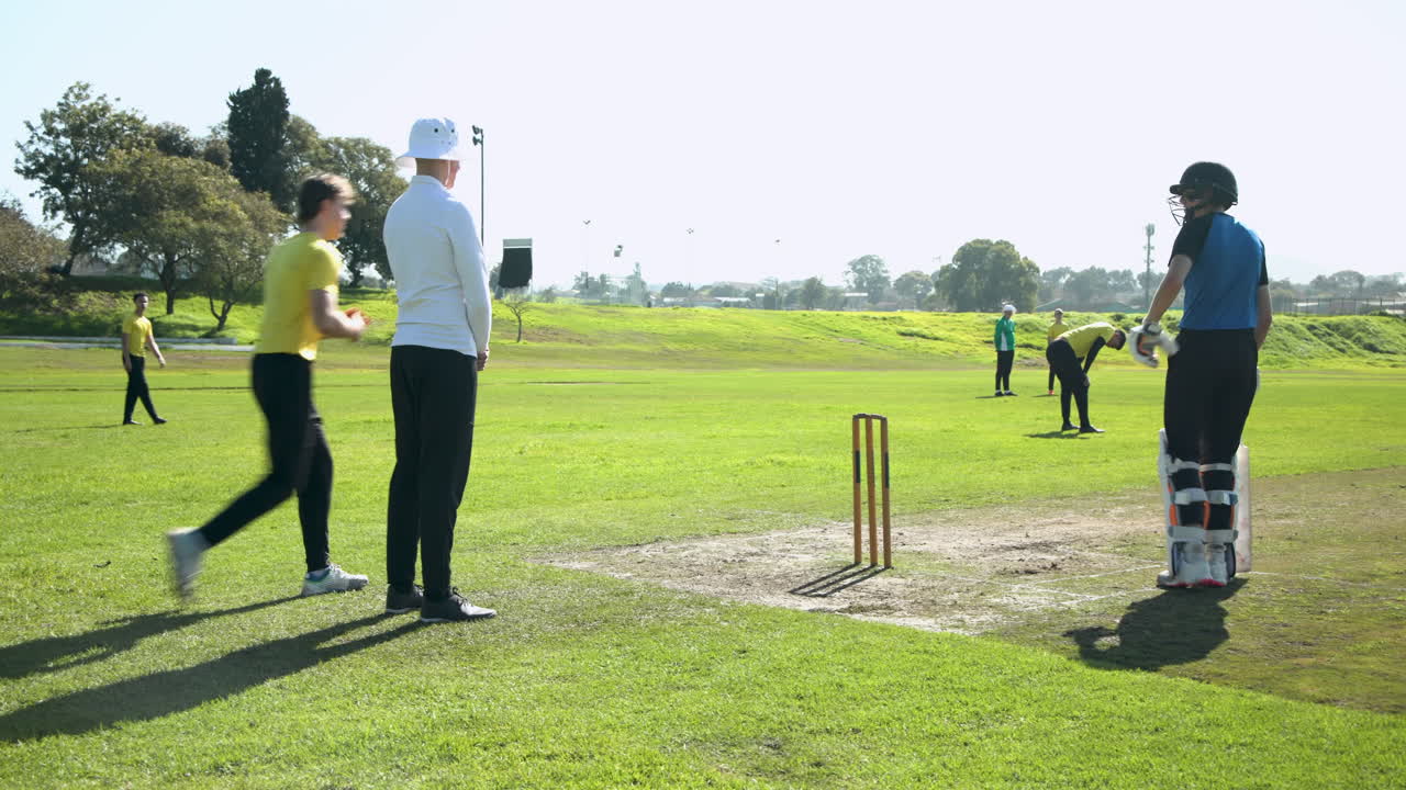 Cricket players running between wickets on sunny field, focusing on teamwork