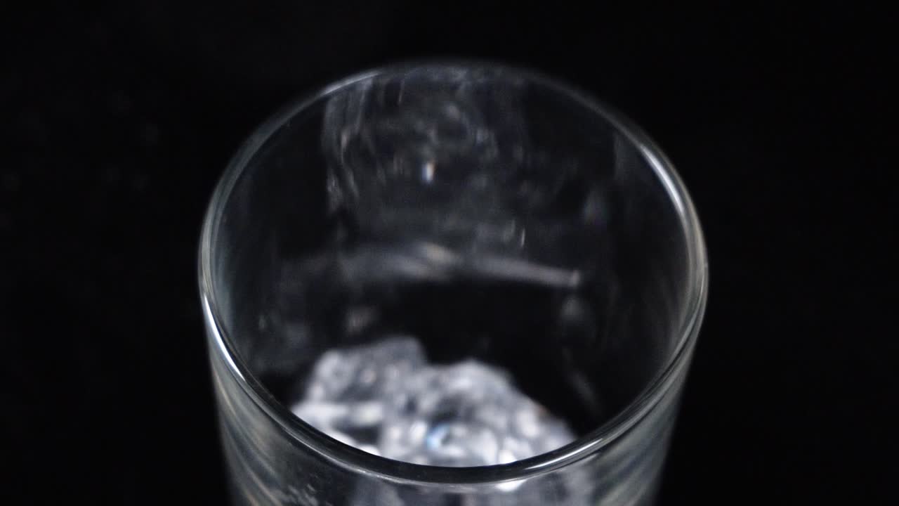 cubos de hielo cayendo en un vaso para una deliciosa limonada fría
