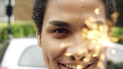 man holding sparkler celebrating independence day