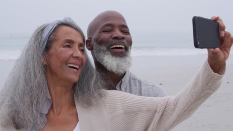mature couple enjoying time outside by the sea