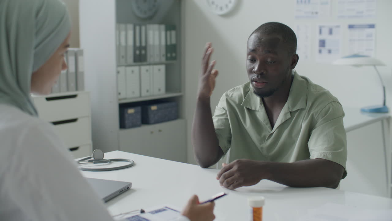 African American Patient Talking to Doctor during Medical Appointment