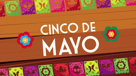 cinco de mayo lettering celebration with garlands in wooden background