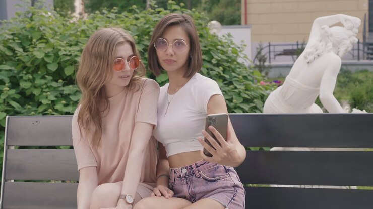 Two friends taking a selfie in a park
