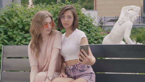 two friends taking a selfie in a park