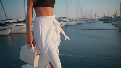 woman walking in a marina at sunset