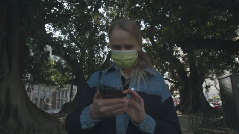 woman walking in street without looking anywhere but the phone