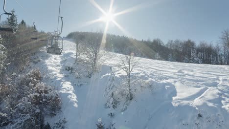 pov riding ski lifts winter snow covered slopes sunny day sunstar