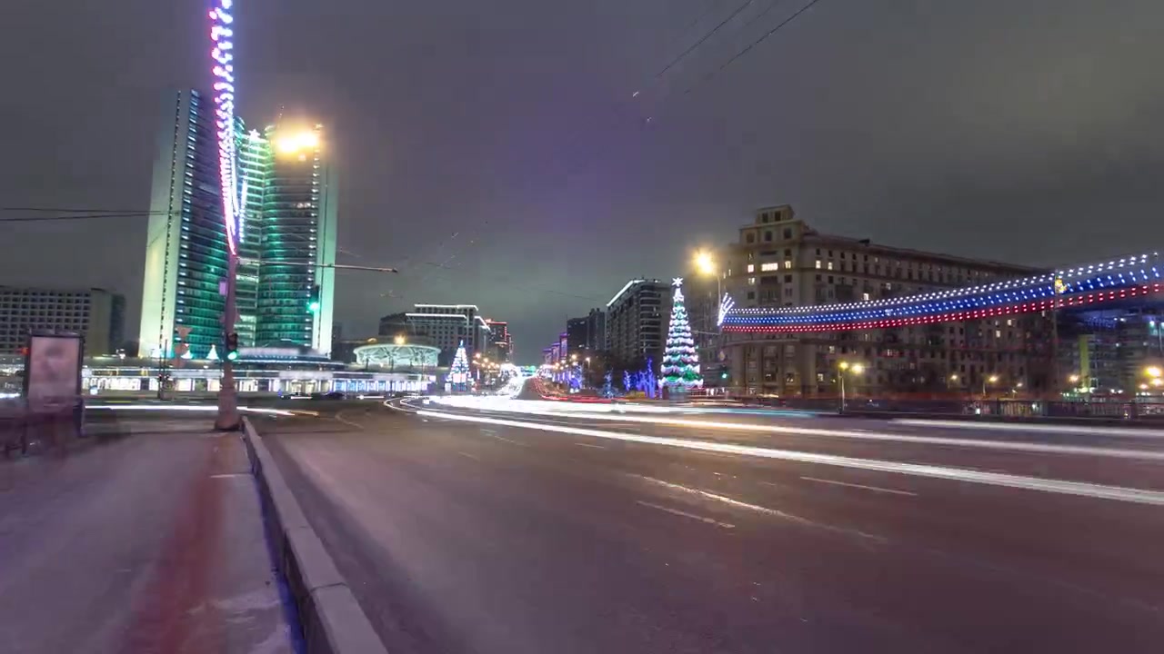 New Arbat Street, a bustling central thoroughfare in Moscow, comes to life in the glittering winter night. Watch as car traffic flows along this iconic street in this captivating timelapse scene