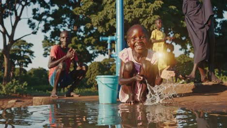 cheerful young girl playing joyfully with water at rural community well, experiencing pure happiness through spontaneous interaction with natural environment under bright sunlight