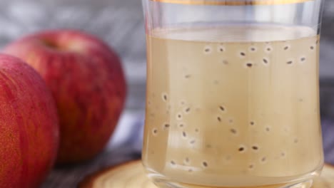 seed apple juice in a glass on table ,