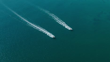 Aerial-view-down-shot,-two-jets-skied-racing-with-each-other-on-the-blue-sea-on-a-sunny-day-in-San-Juanico,-California-Sur,-Mexico