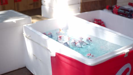 ice cold drinks sitting in a ice cold container on a hot summer day at a festival, matsuri, in kyoto, japan soft lighting slow motion 4k