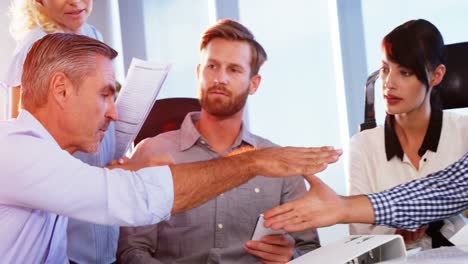Executives shaking hands while working