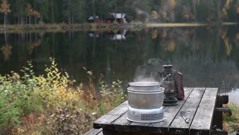 cooking food infront of a small lake with