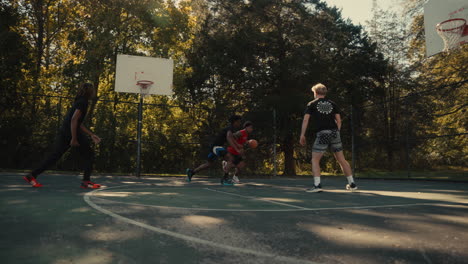 young men playing basketball outdoors