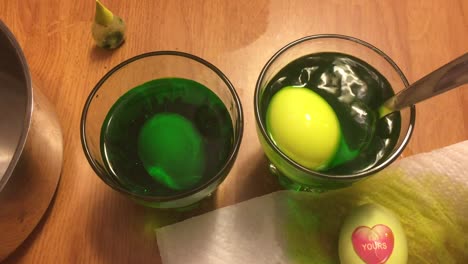 dipping and dying eggs light-green for easter