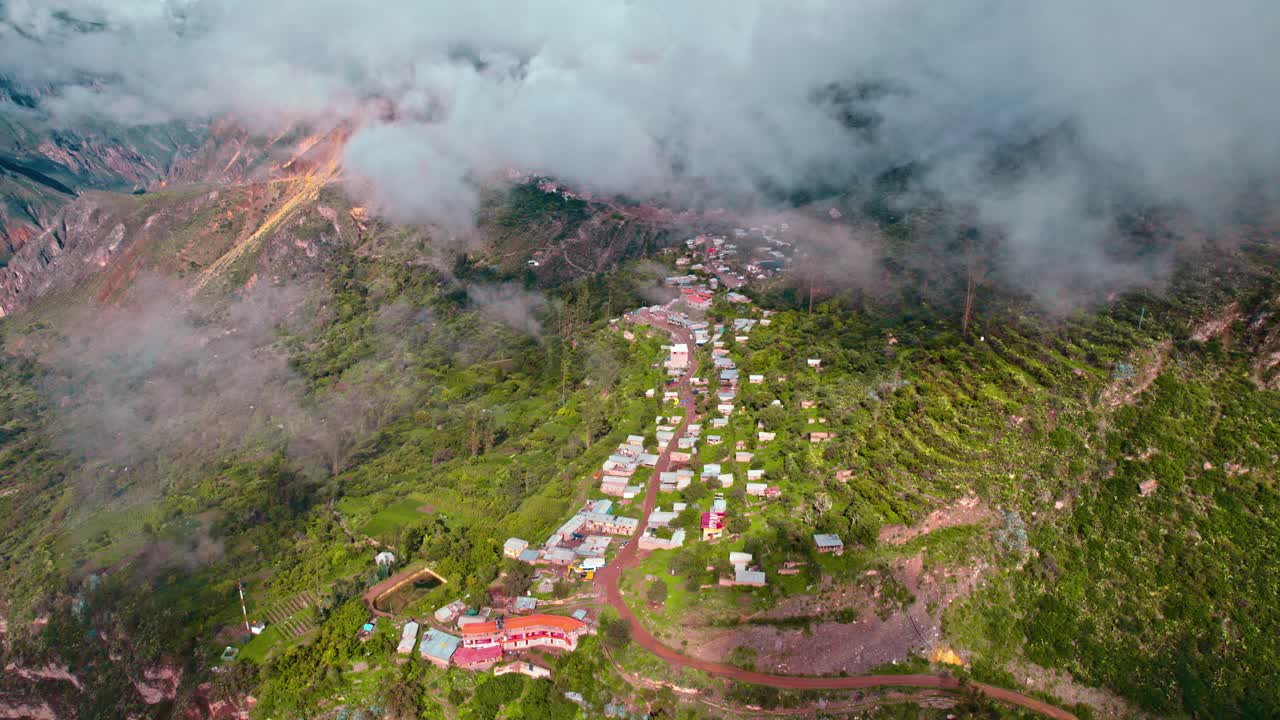Drone descent to Cos&ntilde;irhua-Malata village in Colca Valley, post-rain spring day with cloudy skies