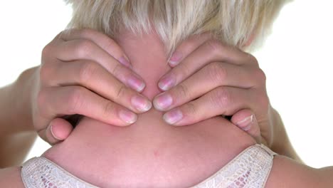 a woman giving a quick massage to her neck with her fingers for relief