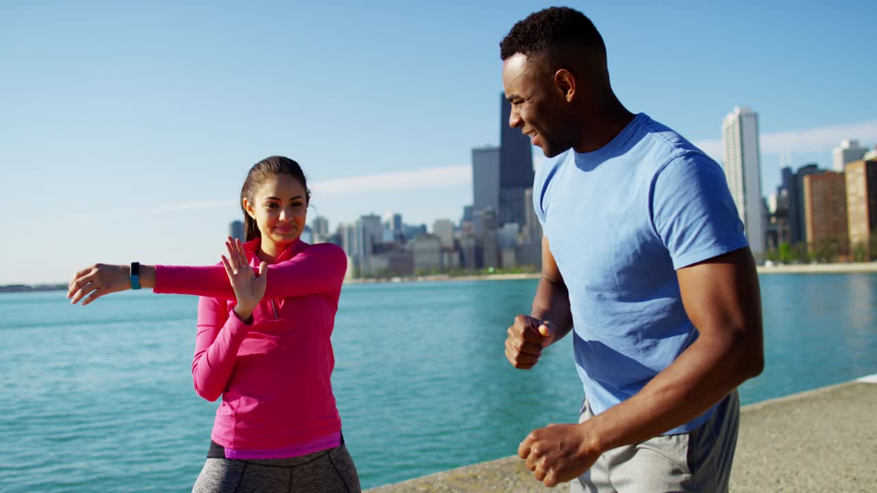 Multi Ethnic people training outdoors by Chicago shoreline