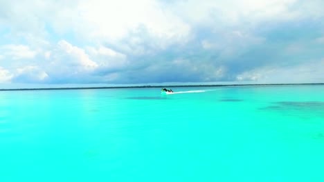 passage of a pleasure boat on a turquoise blue sea in zanzibar