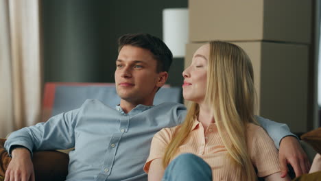 family relaxing new apartment sitting on living room sofa closeup. couple moving