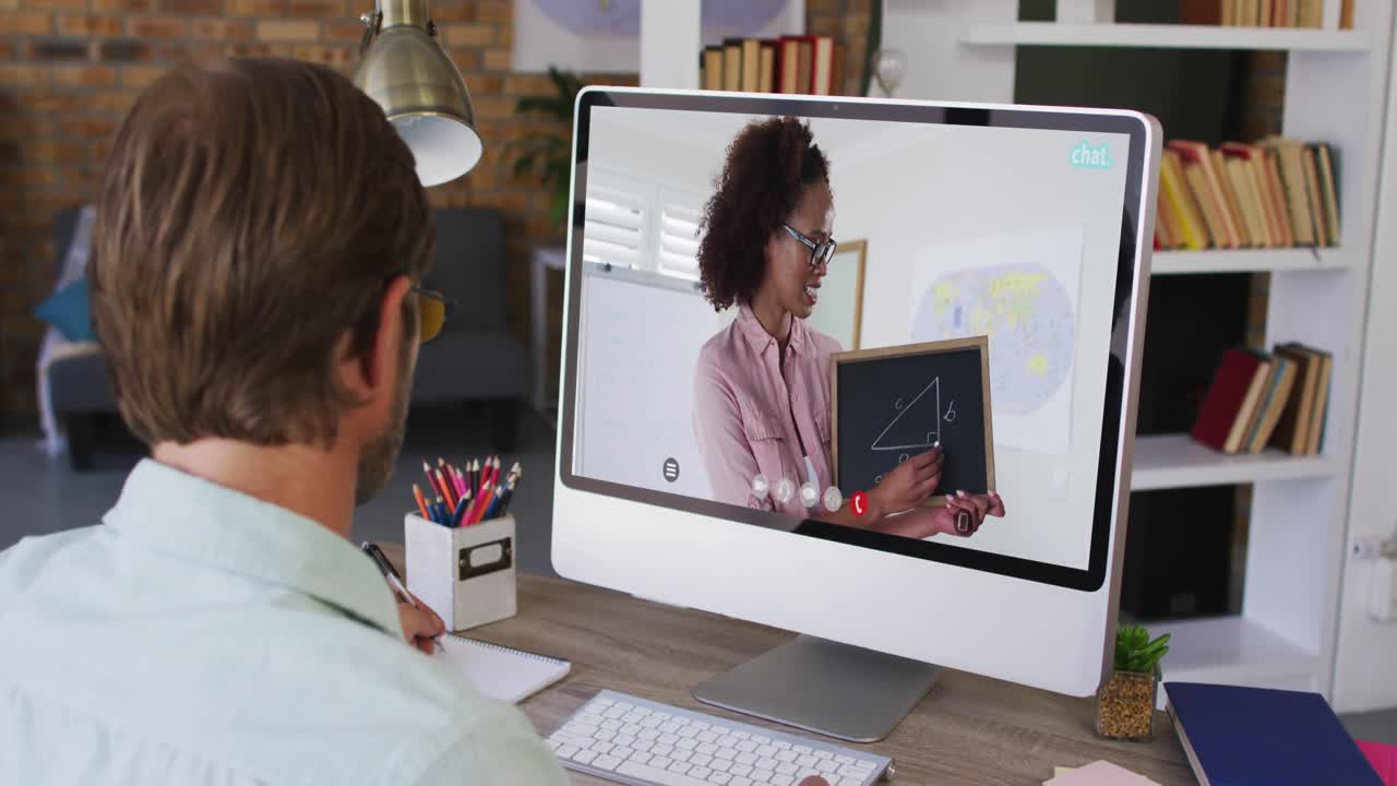 Caucasian male student using computer on video call with female teacher