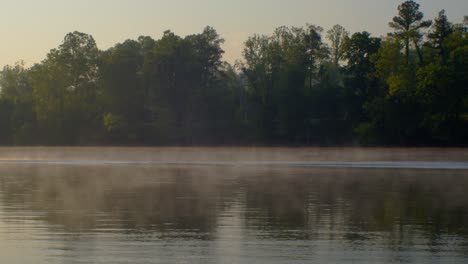 canoe speeding over a foggy river in the morning - new river blacksburg virginia