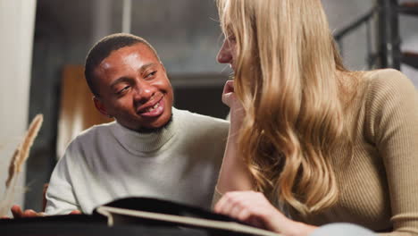 happy man with pretty woman looks at pictures of family