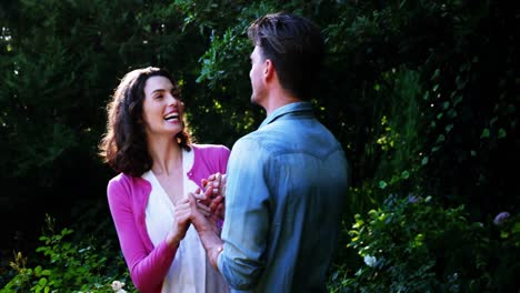 romantic couple interacting with each other in garden