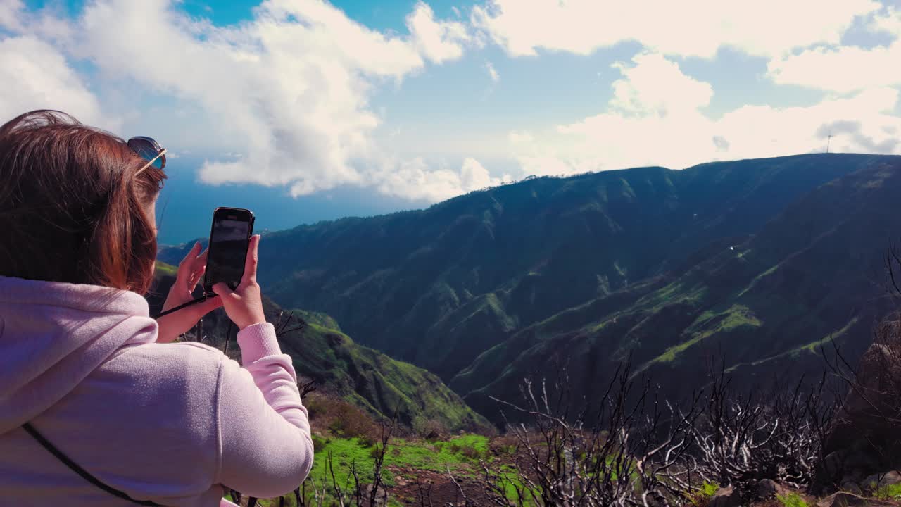 Woman standing at a top of a mountain in Fanal, Madeira island, Portugal