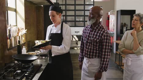 chef adding vegetables on the pan