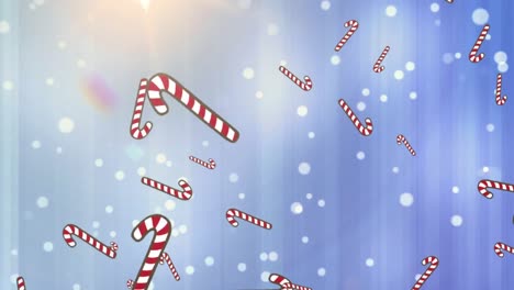 Animation-of-candy-canes-falling-over-glowing-white-spots-on-blue-background