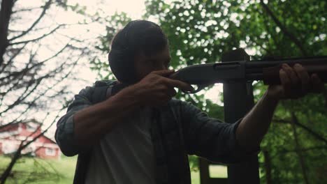 young man holds a shotgun for training in the forest, georgia gun shooting slow motion