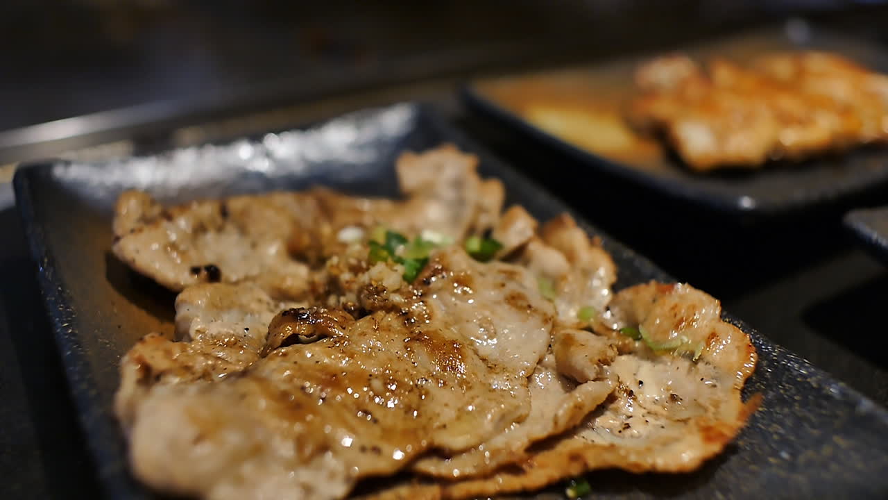Close-up of a skilled chef preparing teppanyaki Japanese cuisine on a hot iron griddle in front of guests, grilling fresh ingredients with flair. Perfect for Japanese food culture and live cooking