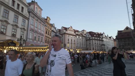 establishing shot of old town square in prague, czechia, featuring its historic buildings and vibrant atmosphere