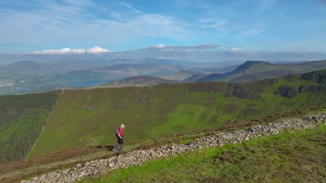 Mountain-walker-striding-up-high-path