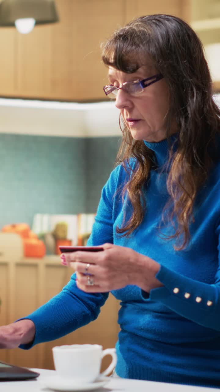 Vertical Video Senior woman entering card numbers for online grocery shopping on website