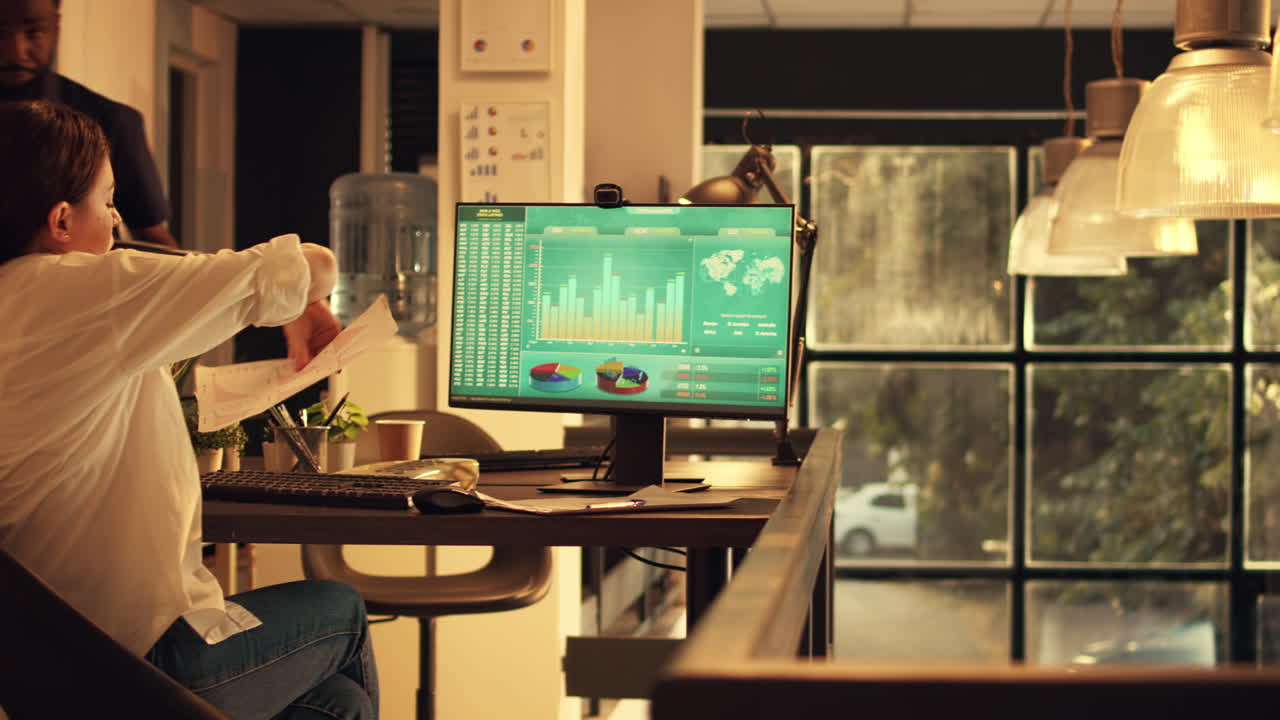 Employee working with landline phone and financial sales data