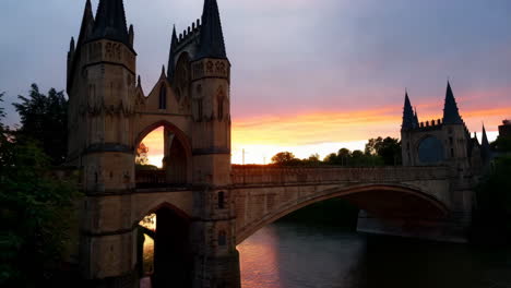 dramatic sunset over historic bridge and gothic architecture