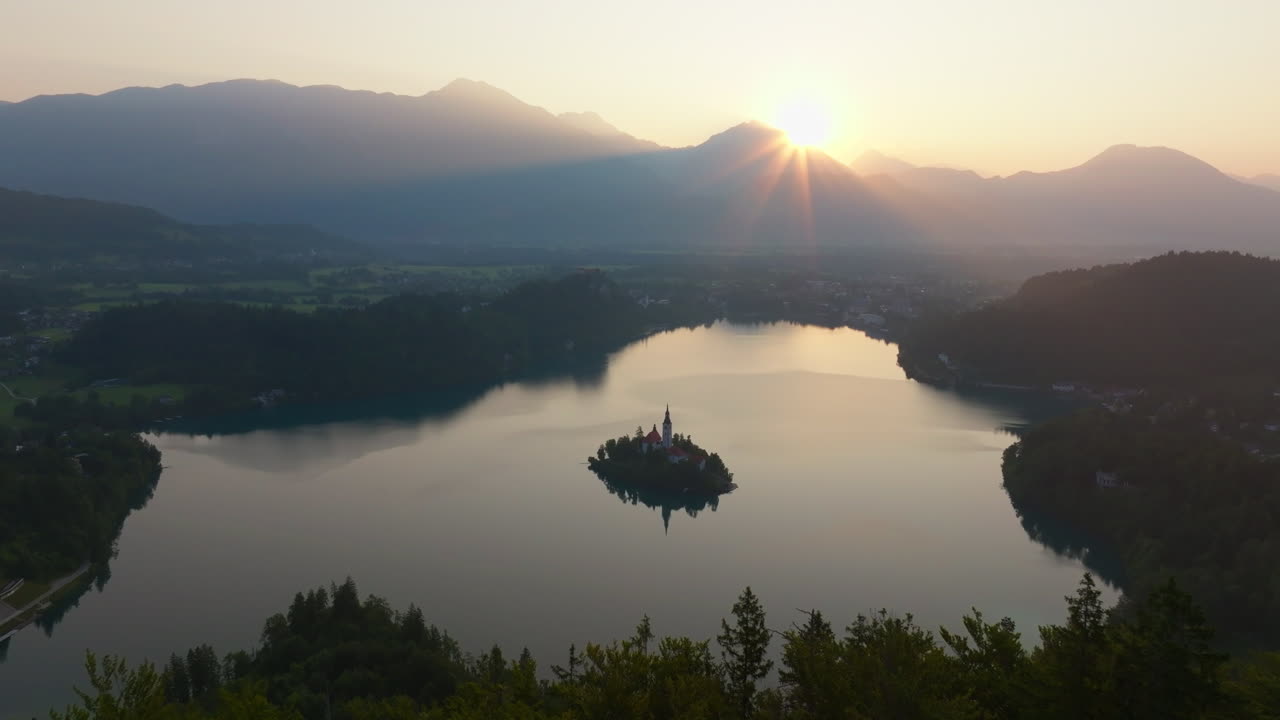 Lake Bled Sunrise – Aerial View with Island Church and Forest Hills