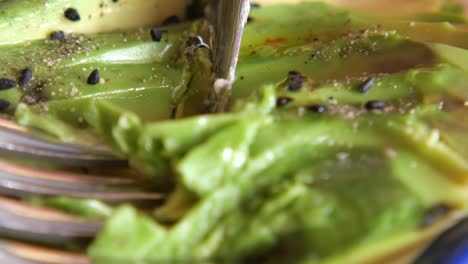 sliced avocado with fork and knife
